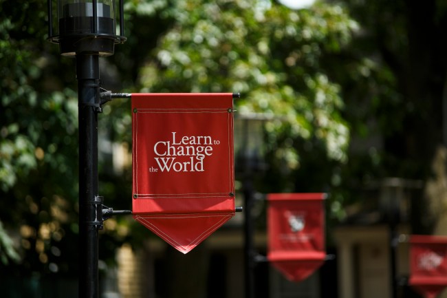 “Learn to Change the World” banners fly outside