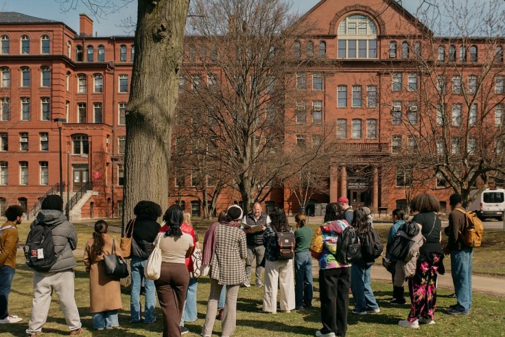 A group of people gathered outside of a brick building museum