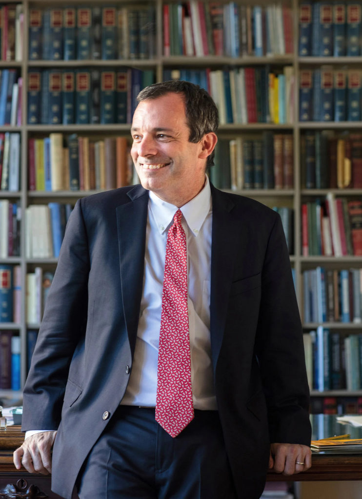 John F. Manning smiling in his office