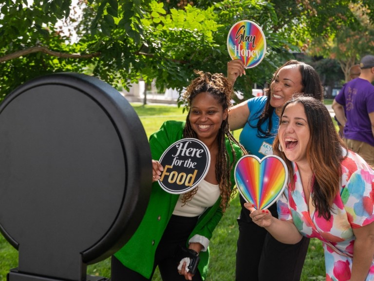 Three women getting their photo taken