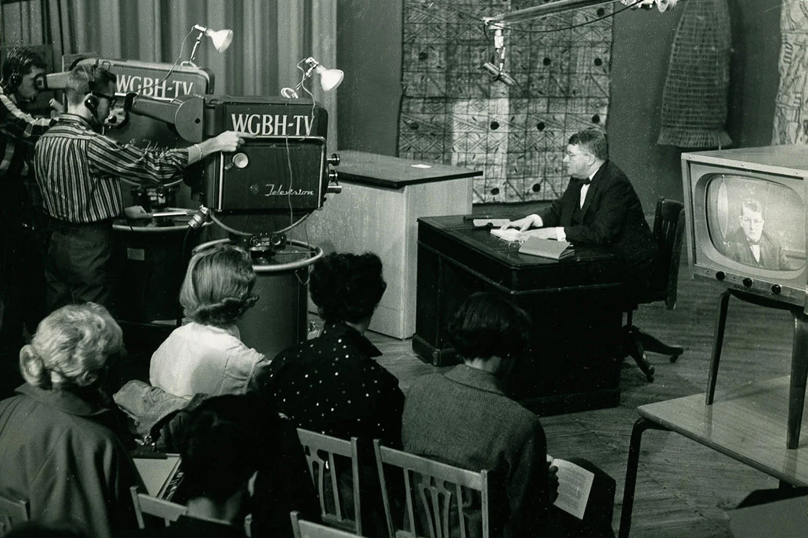 A professor teaching a course on a television set