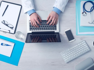A doctor working on a computer