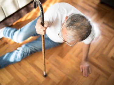 A man with a cane falling
