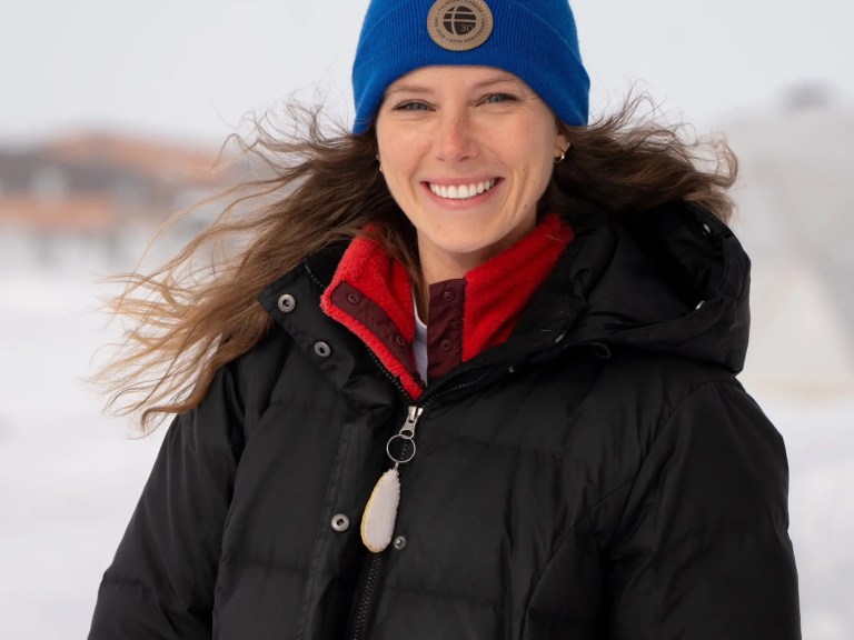 A woman in a blue hat in the Arctic