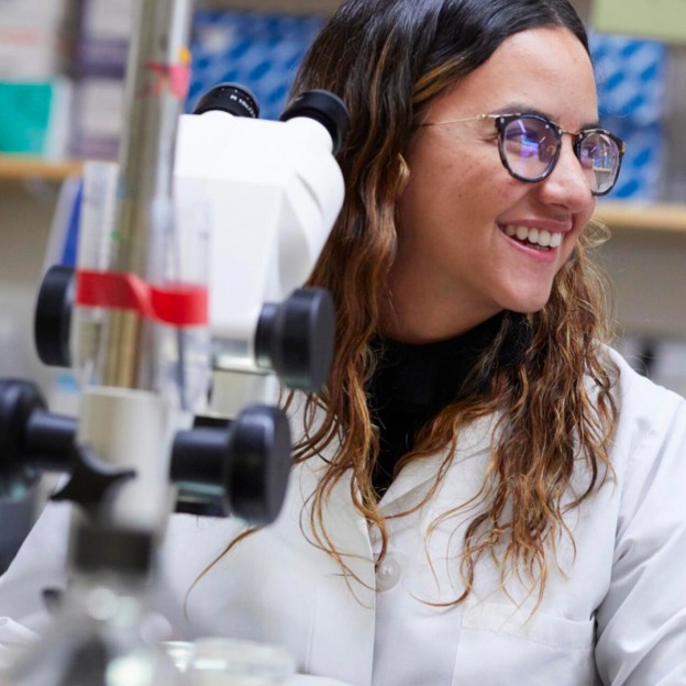 A woman at a microscope